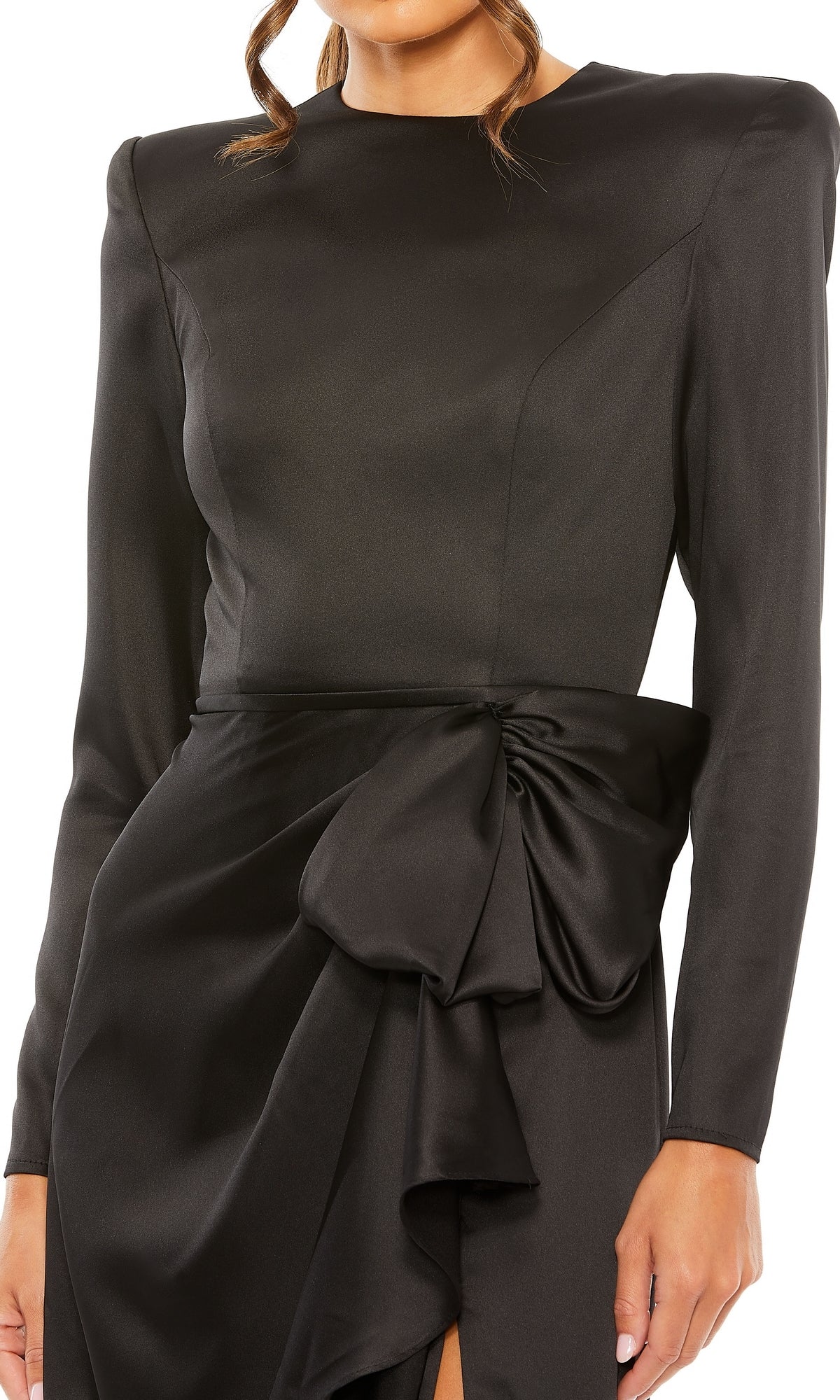 A woman wearing the Mac Duggal 26676 Bold-Shoulder Long Formal Dress in black, featuring bra-friendly styling and a large waist bow.
